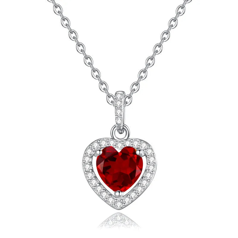 Heart-shaped sterling silver pendant necklace with a natural gemstone on an adjustable chain.