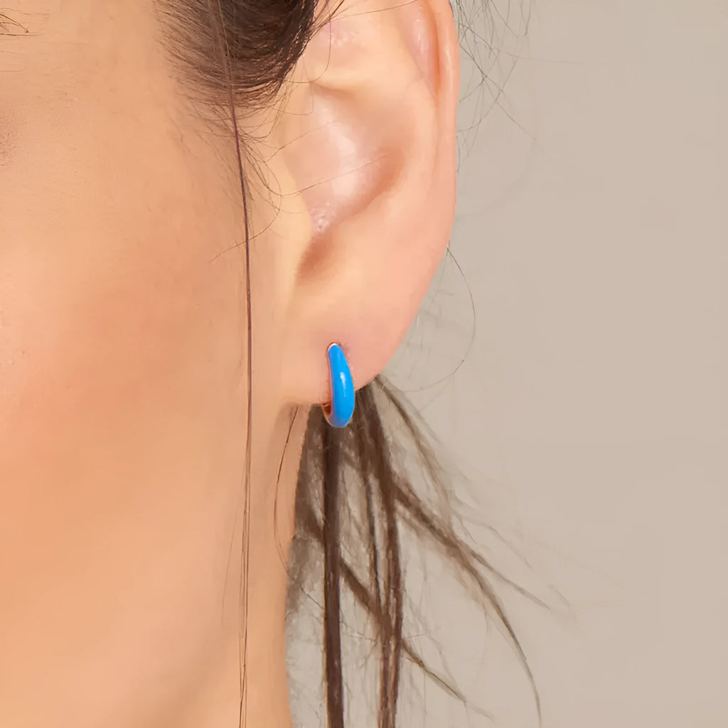 Geometric U-shaped oval epoxy earrings in dripped oil colours on copper wire.