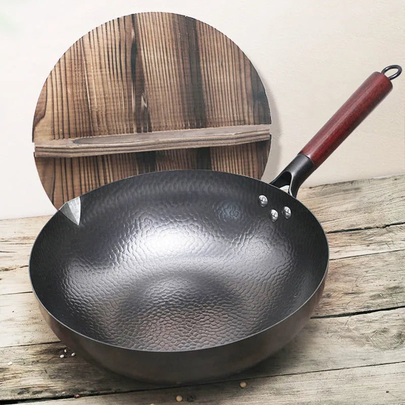 Traditional black iron wok with wooden handle showing 40cm diameter and flat induction base