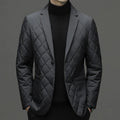 Man wearing a solid colour thickened lapel down jacket with side seam pockets.