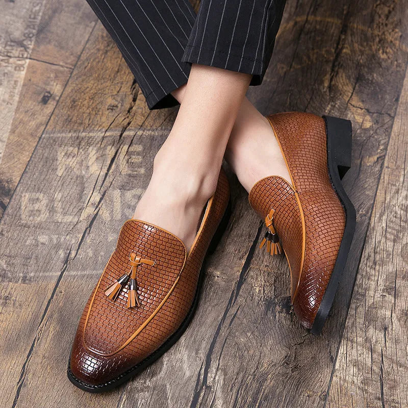 Men's black pointed toe slip-on shoes with a tassel detail on the vamp