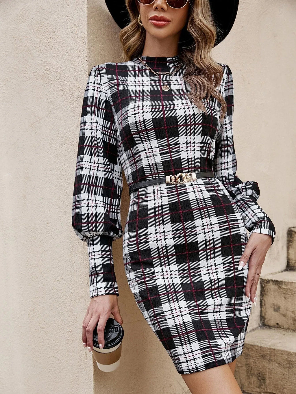 Black women's tight dress with lantern sleeves and leather stitching detail in mid-length design