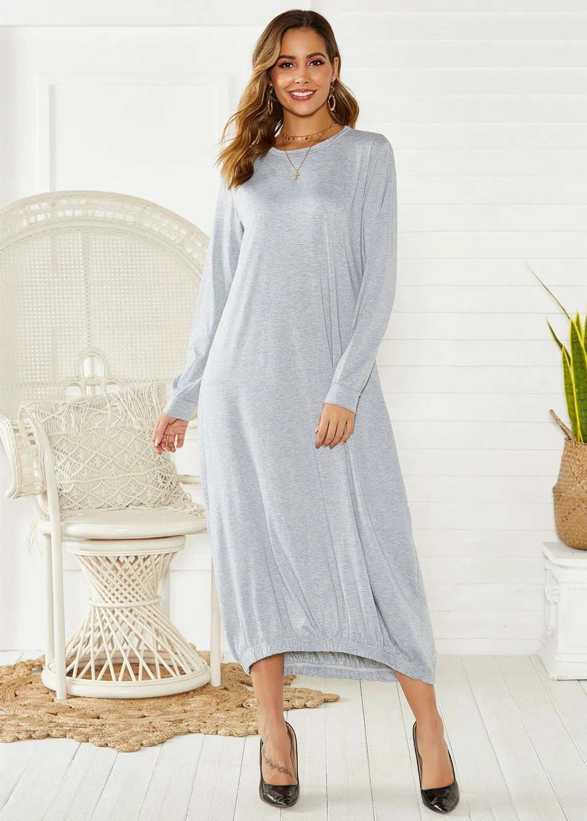 Loose black lantern dress with a lace-up crew neck, showcasing a relaxed silhouette.