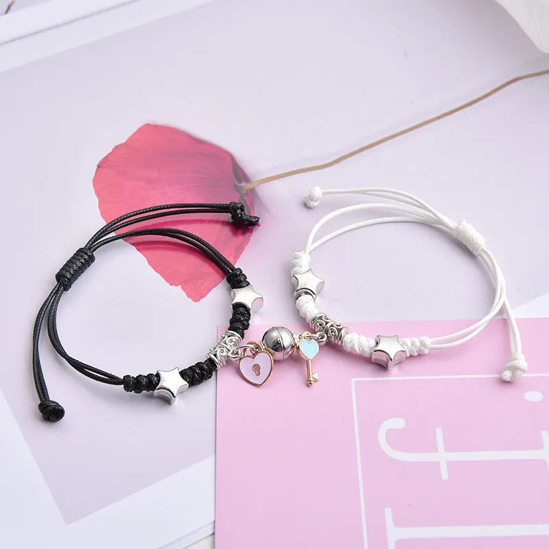 Pair of alloy suction bracelets with engraved symbol choices including crown, love lock, and clover.