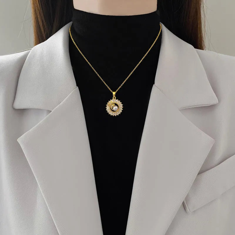 Women's geometric jewellery set showing necklace and earrings with ring and leaf designs in gold and silver tones