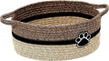 Light beige handmade cotton rope storage basket with wooden handle on a table.