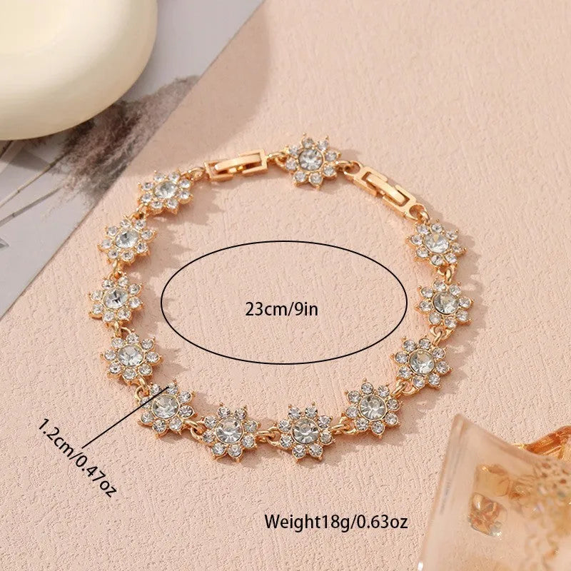 Electroplated zinc alloy bracelet with flower-shaped coloured gemstone charm in gold and silver colour variations