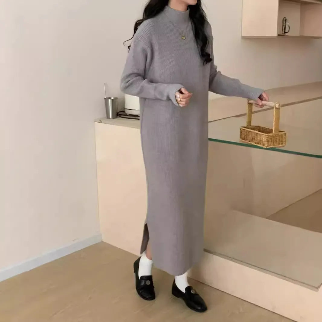 Woman wearing a beige half-turtleneck, high-waisted, knee-length acrylic knit dress.