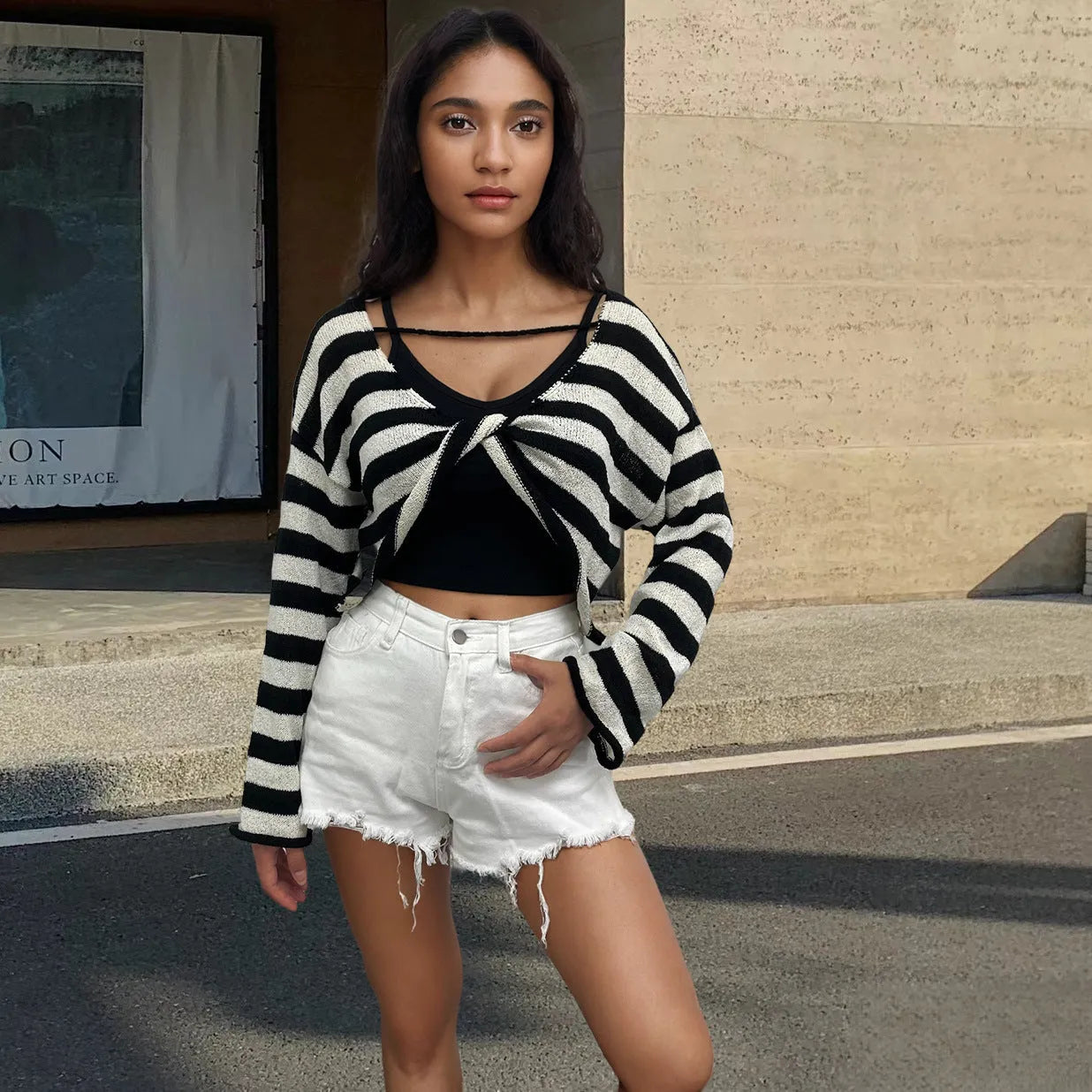 Striped long-sleeve women's pullover sweater in mercerised cotton showing exposed navel style.