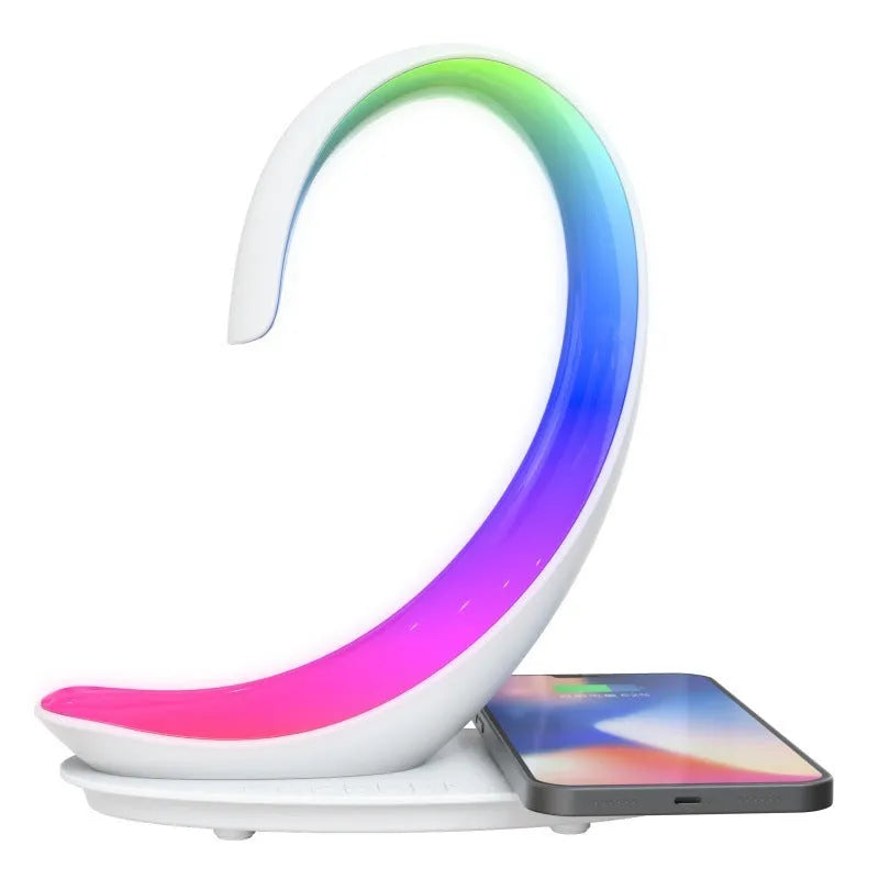 White swan wireless charging Bluetooth speaker with colourful ambient lighting on desktop