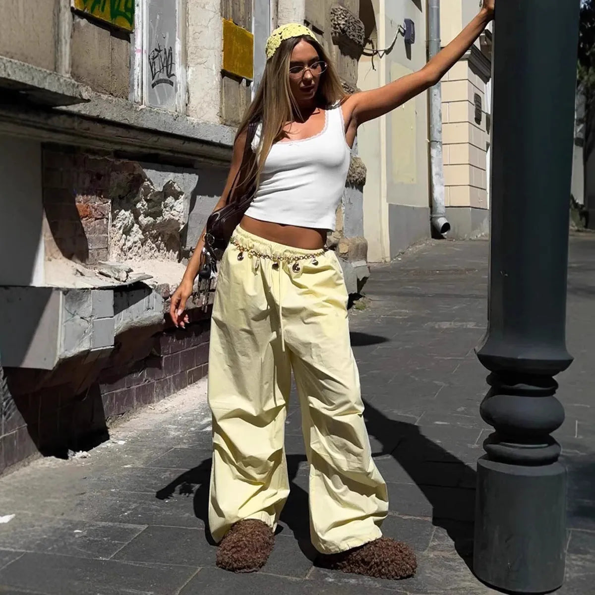 Women's polyester drawstring loose casual trousers in solid yellow colour on model