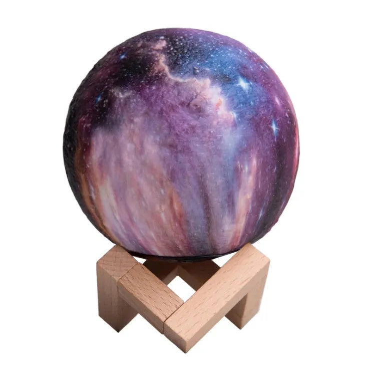 3D printed white lunar night light with colour-changing LED sphere on a stand, showing remote control.