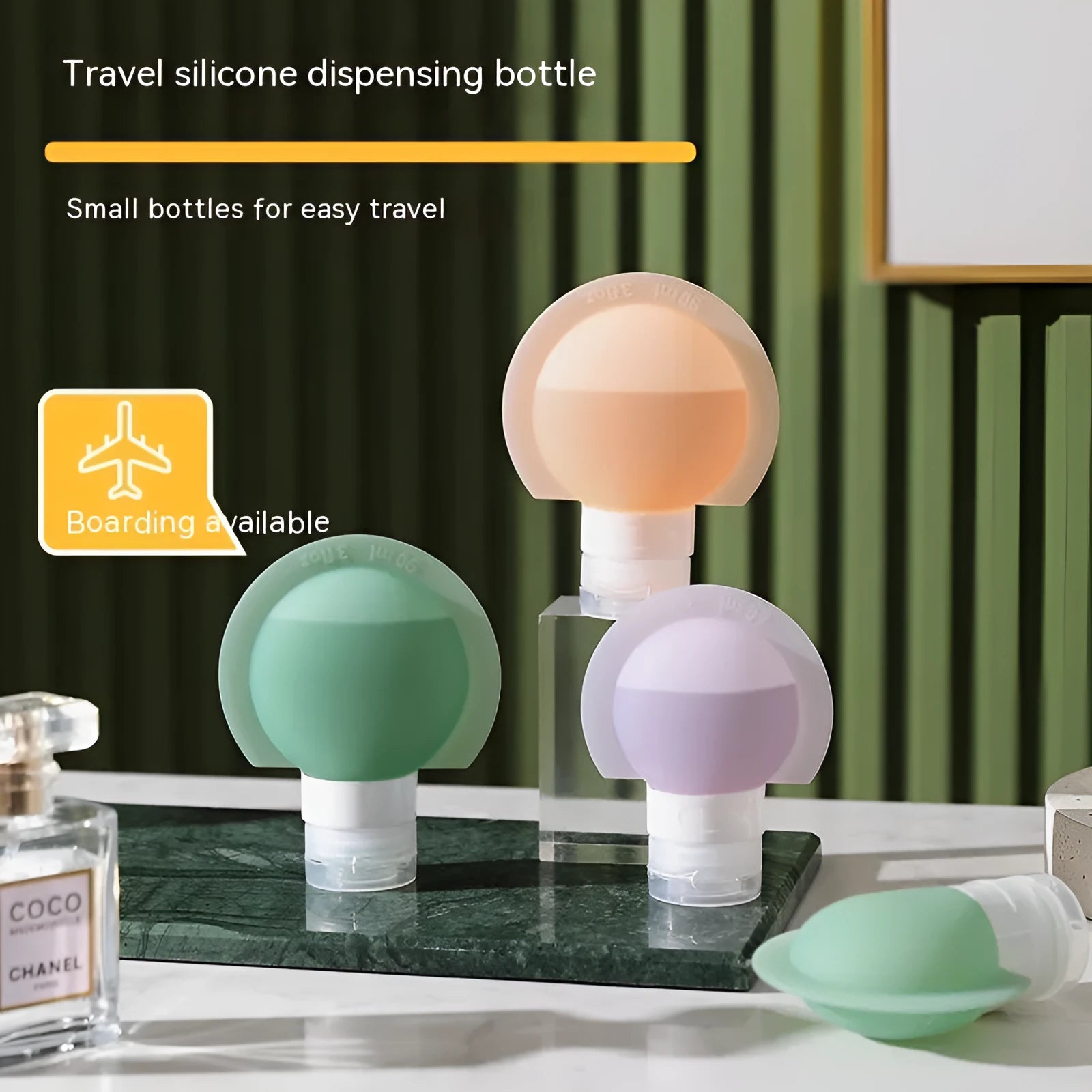 Three silicone travel storage bottles in mixed colours with stickers on a white background