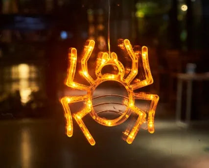 Set of seven battery-powered Halloween LED hanging lights with ghost, spider, and pumpkin designs for window decoration.