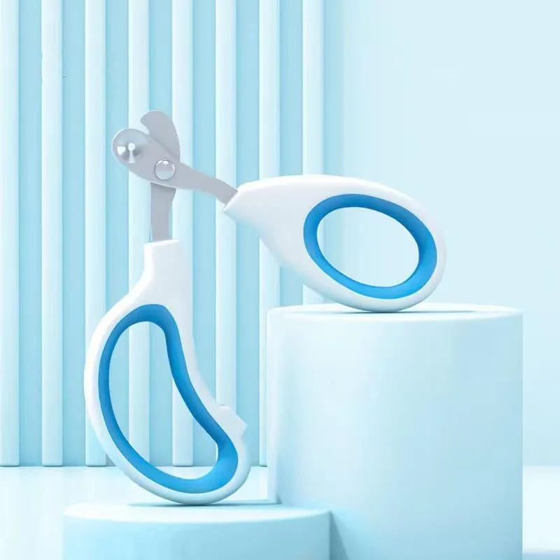 Blue pet nail clippers with circular cut hole and non-slip grip handles on a white background