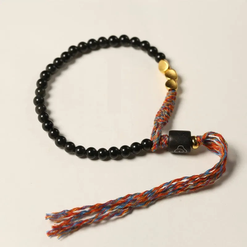 Hand-woven obsidian carrying strap showing texture and 4mm width