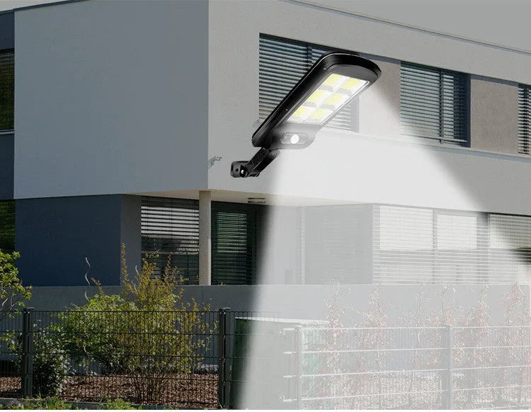 Black solar-powered outdoor street light with motion sensor for garden and driveway illumination