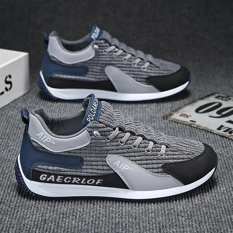 Men's lightweight mesh running shoe in green or grey with lace-up front and round toe
