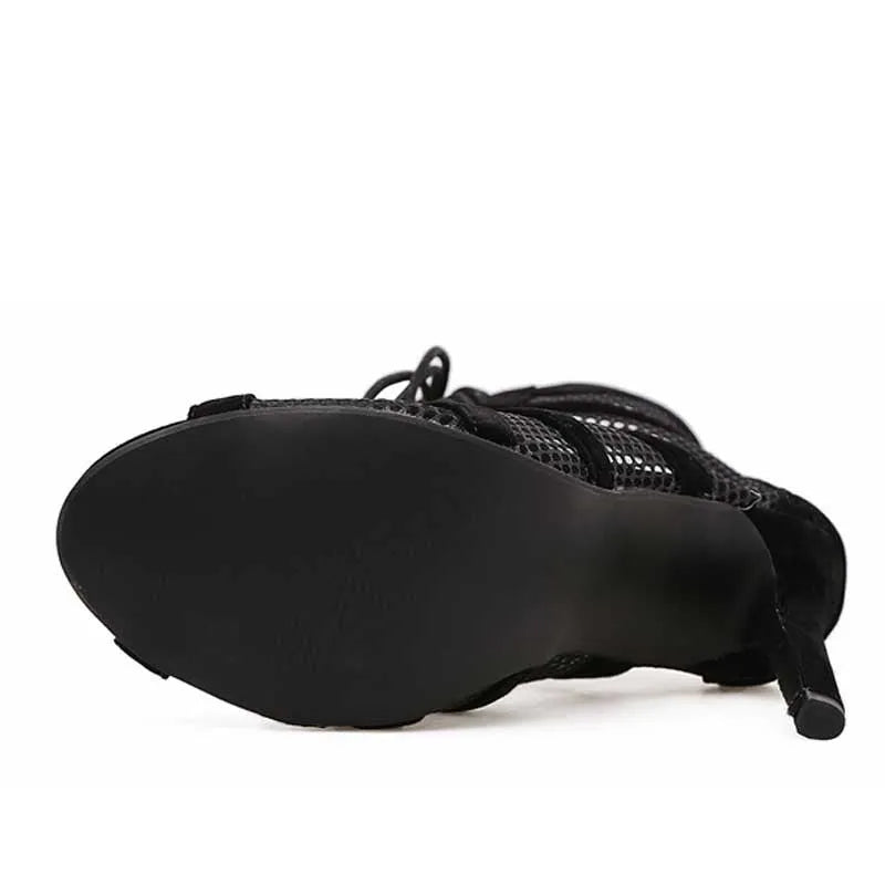 Black suede lace-up high heel women's shoes with 11.5cm heel on wooden surface