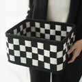 Grey and white checkerboard woven folding felt storage basket showing collapsible design