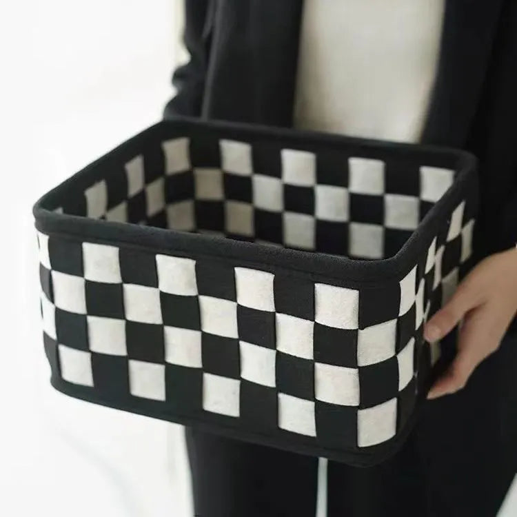 Grey and white checkerboard woven folding felt storage basket showing collapsible design
