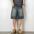 Blue denim men's shorts with distressed holes and straight cut design on mannequin