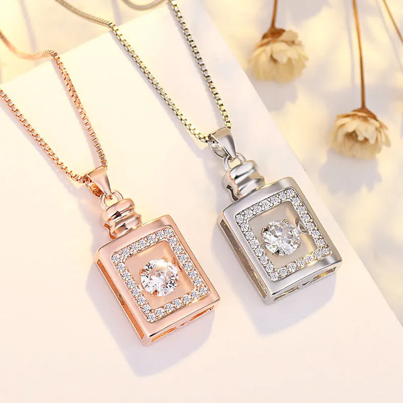 Heart-shaped sterling silver necklace with crown and bow pendant details