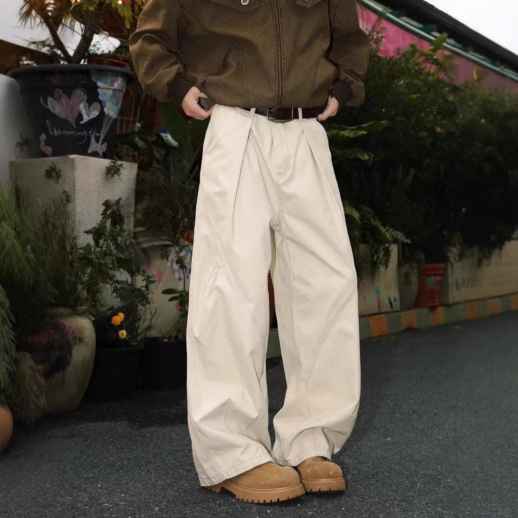 Men's pleated straight-leg trousers in apricot colour showing elasticated waistband detail.