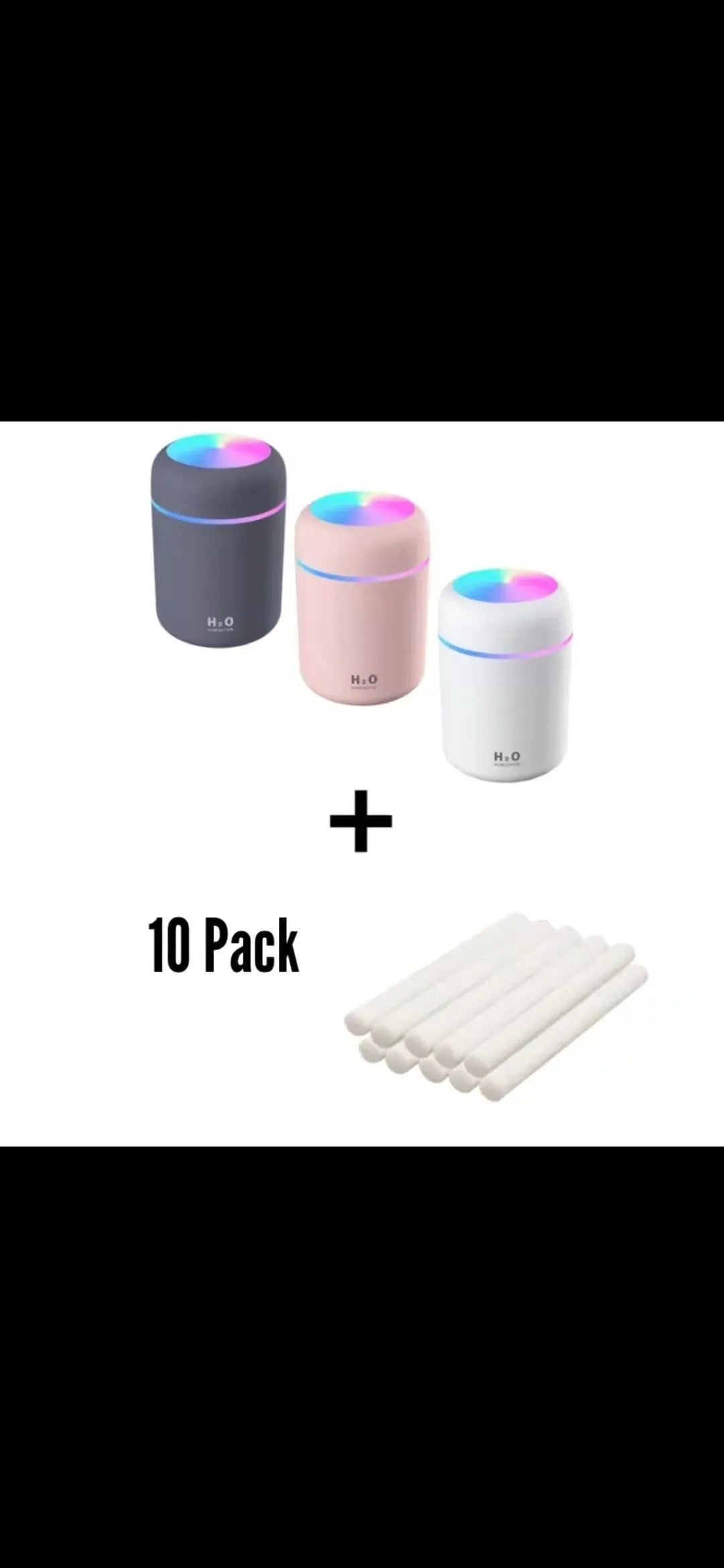 Pink USB desktop humidifier with coloured lights and water tank on a wooden desk
