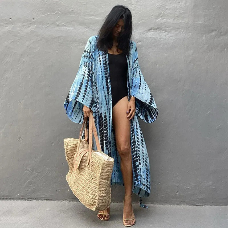 Loose-fitting cotton beach cover-up blouse in a printed pattern, shown in a rust red colour.