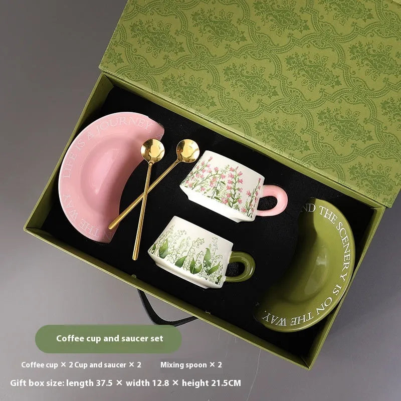 Ceramic coffee cup and saucer set with two spoons, shown in campanula and lanling grass designs.