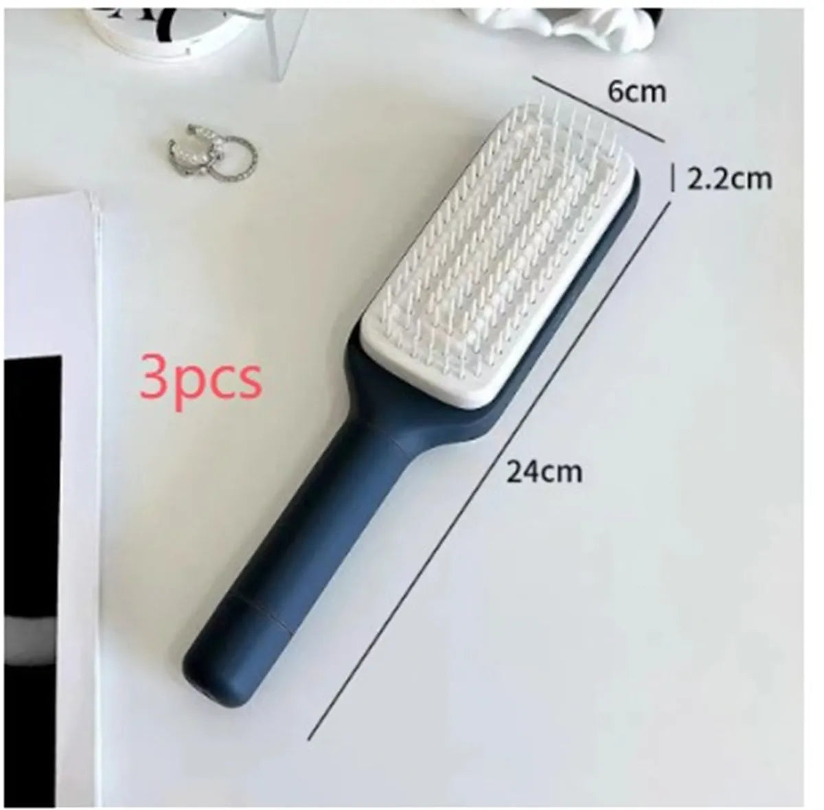 Self-cleaning hair brush with rotating handle, anti-static teeth and scalp massage points in purple and grey colours