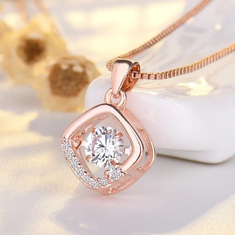 Heart-shaped sterling silver necklace with crown and bow pendant details