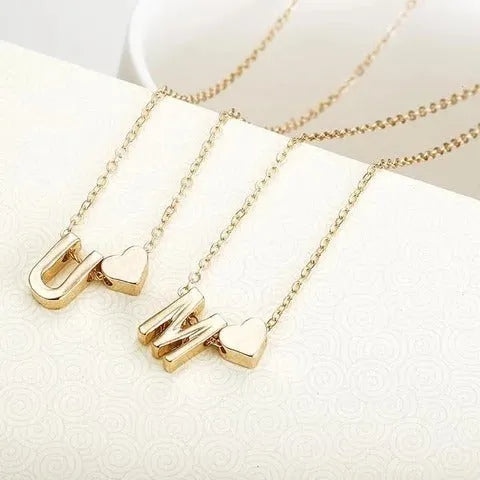 Peach heart shaped alloy pendant necklace charm in a gold colour finish on a model.