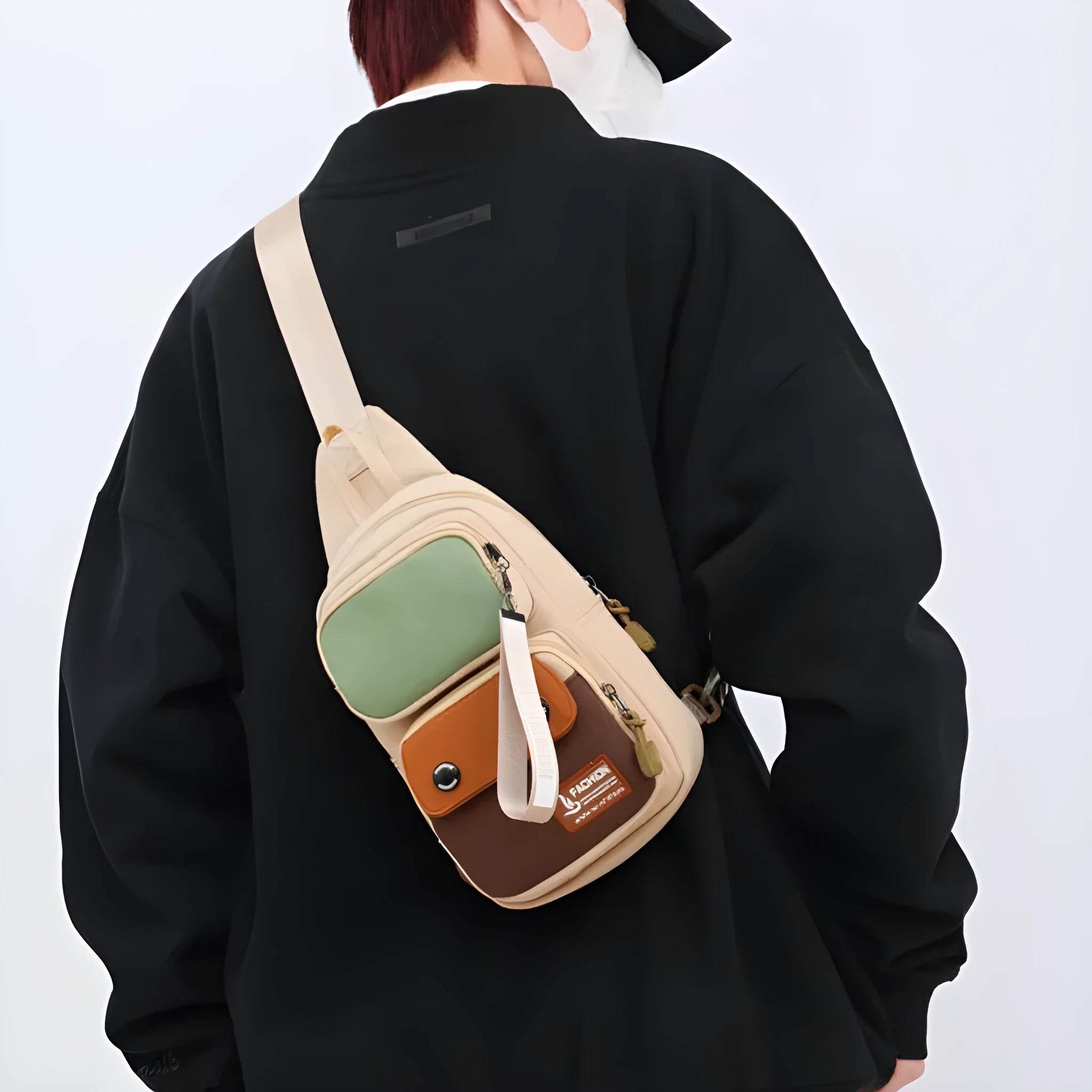 Black nylon crossbody shoulder bag with beige contrast stitching and multiple storage compartments