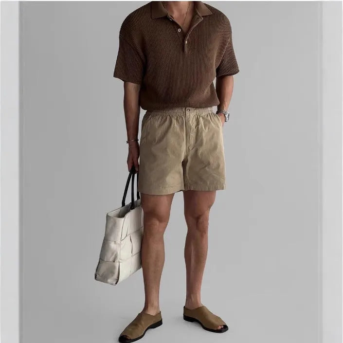 Men's loose-fit cotton sports shorts in black, shown on a white background