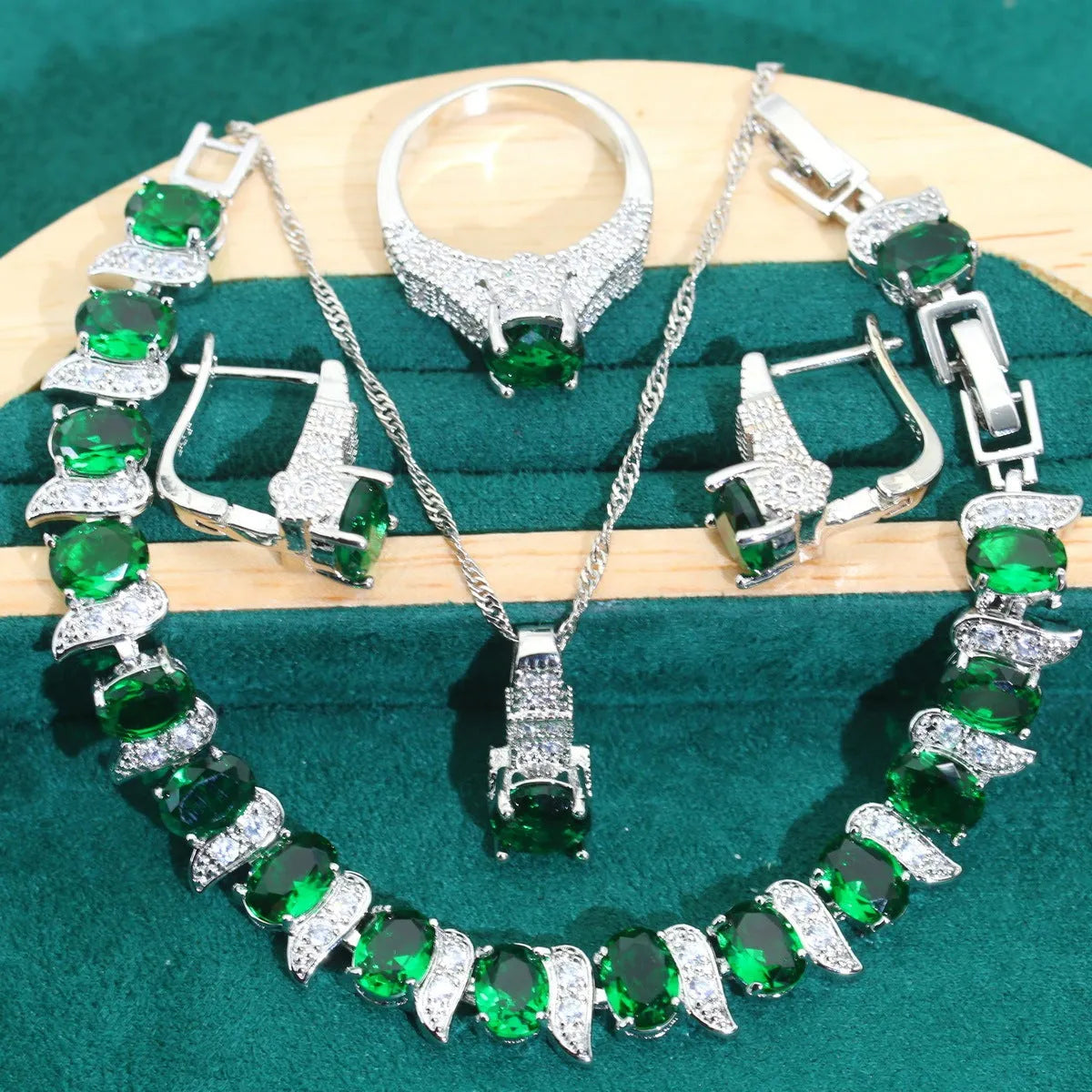 Four-piece bridal jewellery set showing necklace, earrings, ring, and bracelet with alloy pendant and water wave chain