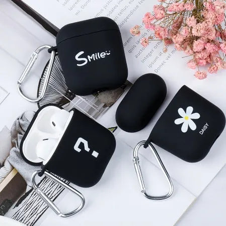 Black and pink Apple AirPods protective case with decorative back cover showing flower and smiley face designs