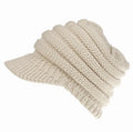 Women's knitted ponytail beanie with hair hole opening in acrylic yarn, shown in beige colour