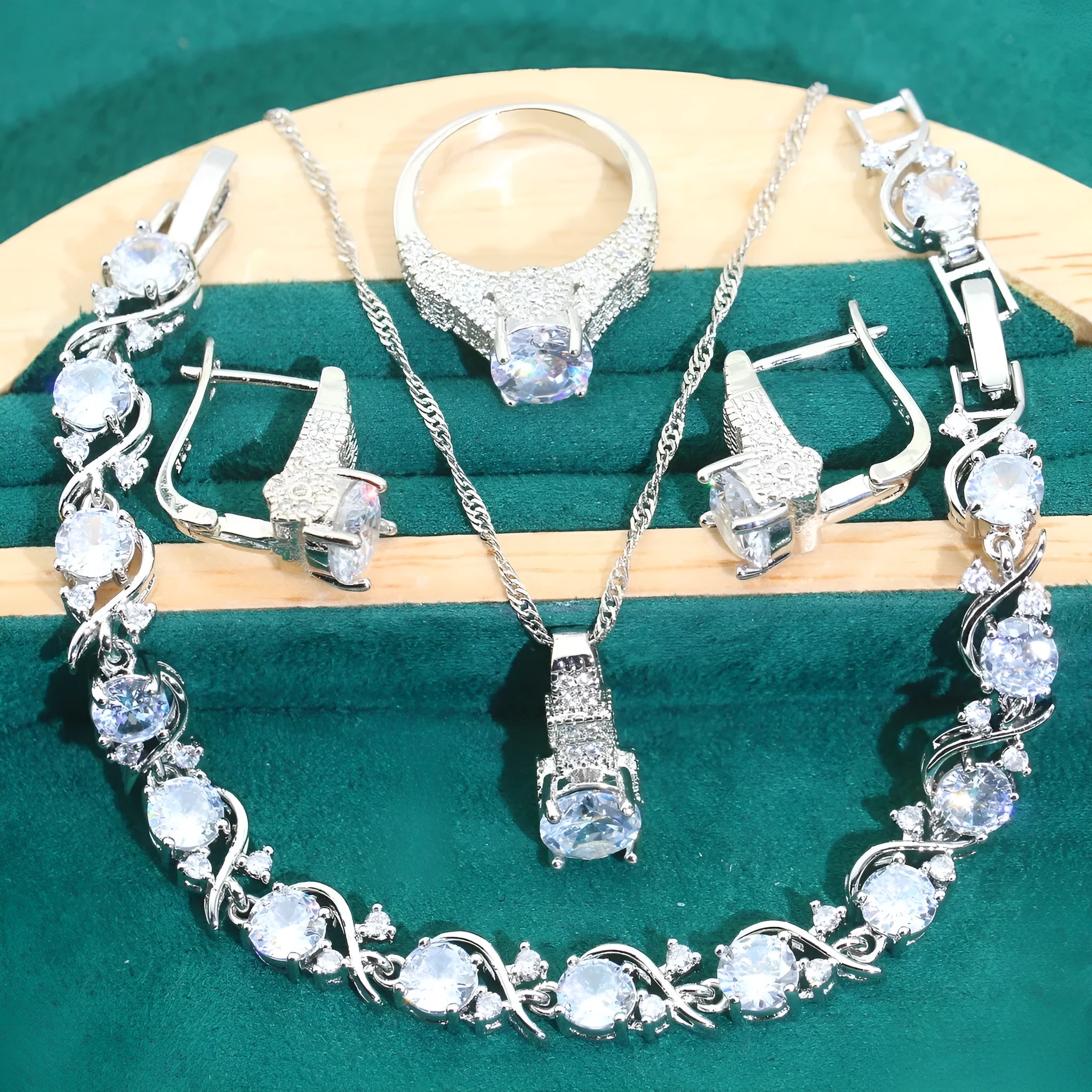 Four-piece bridal jewellery set showing necklace, earrings, ring, and bracelet with alloy pendant and water wave chain