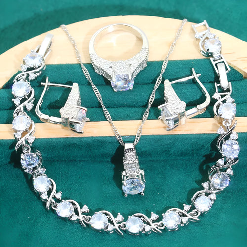 Four-piece bridal jewellery set showing necklace, earrings, ring, and bracelet with alloy pendant and water wave chain