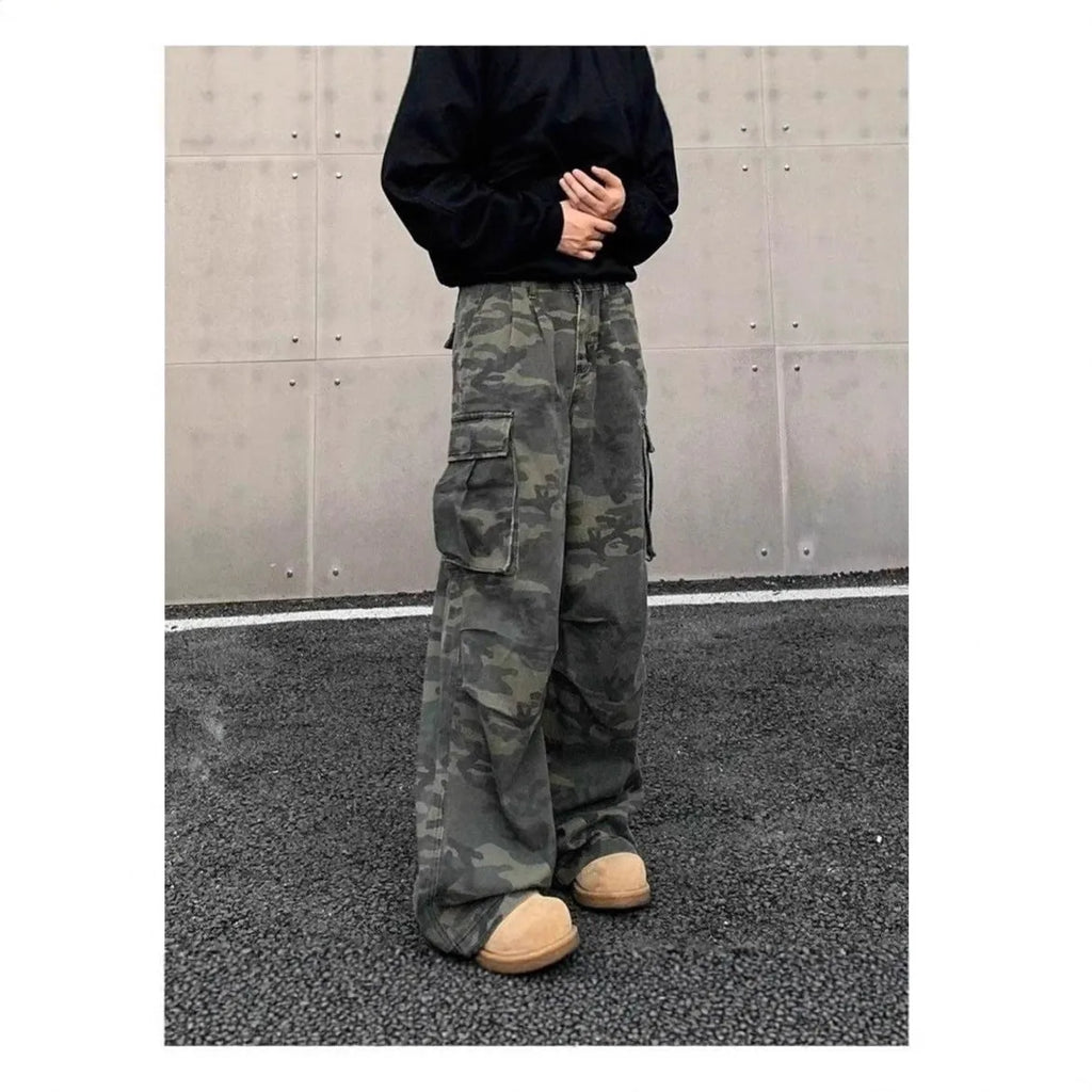 A pair of washed camouflage print cargo pants with multiple pockets on a mid-waist, showing the full trouser length.