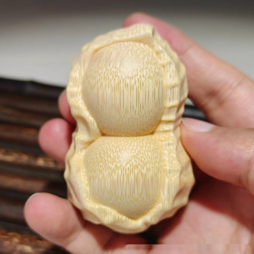 Carved bamboo peanut ornament with natural texture symbolising may good things happen