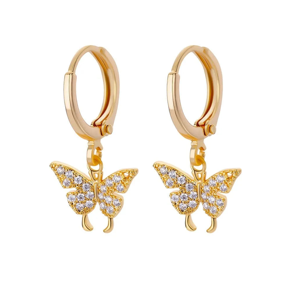 Geometric butterfly-shaped earrings with heart, bow, and star details in copper with a diamond-cut finish.