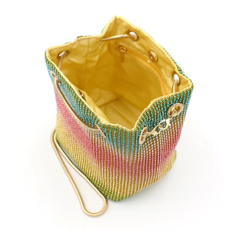 Small rainbow-coloured rhinestone bucket bag with a soft fabric construction.