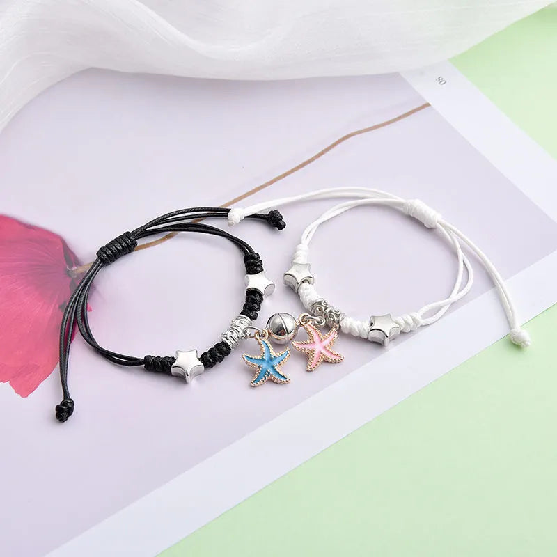 Pair of alloy suction bracelets with engraved symbol choices including crown, love lock, and clover.