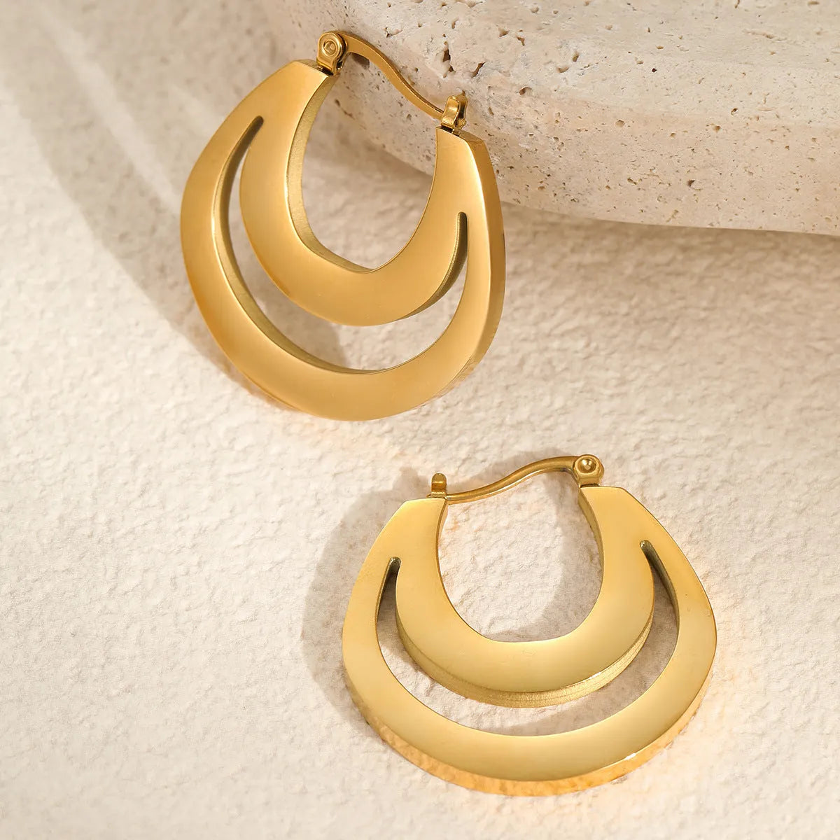 Geometric circular French earrings with gold plating on stainless steel, minimalist design