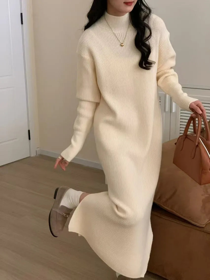 Woman wearing a beige half-turtleneck, high-waisted, knee-length acrylic knit dress.