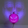 Plastic pumpkin-shaped decorative lamp with USB cable, showing purple or yellow light option.