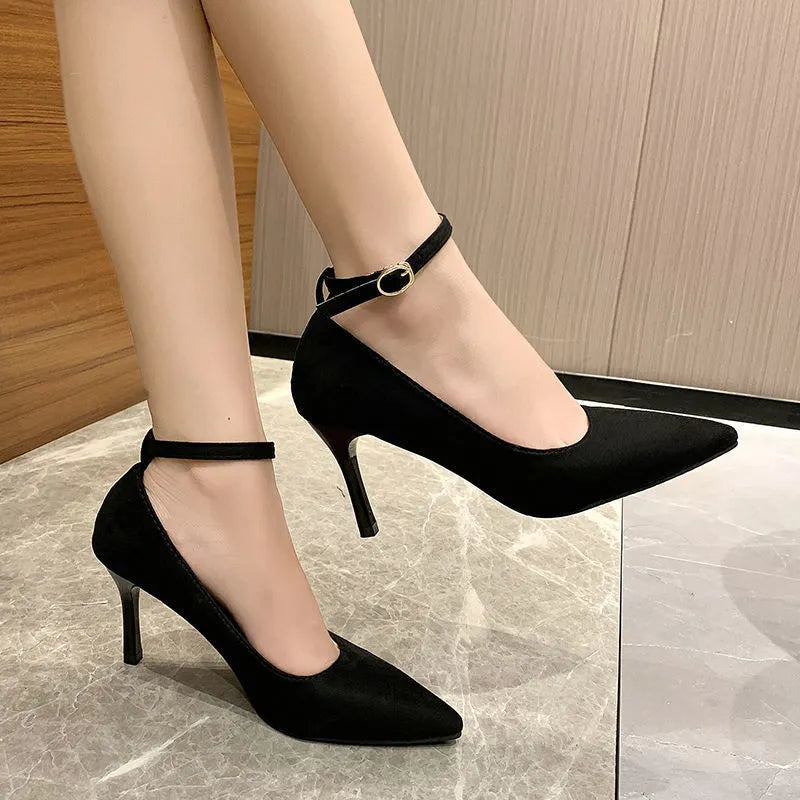 Black women's stiletto heel pump shoes with a skull pattern and ankle buckle on a rubber sole.